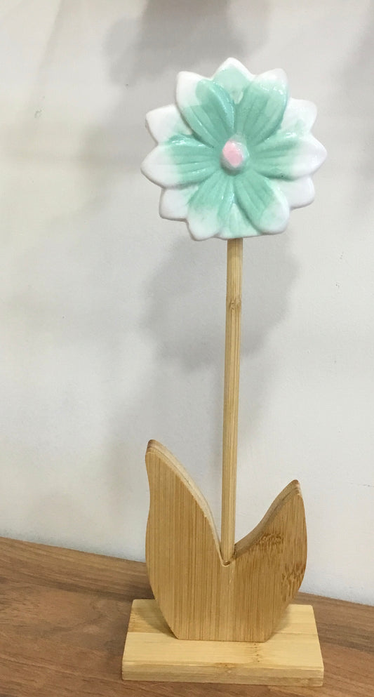 Tall ceramic flower on wooden base