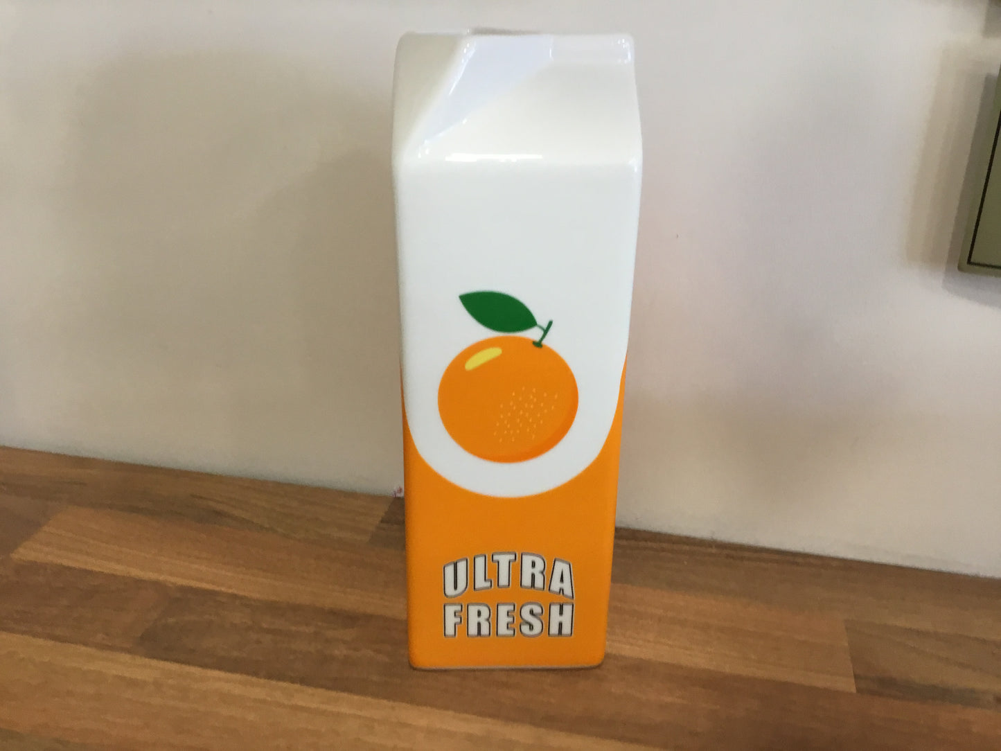 Ceramic orange juice carton vase
