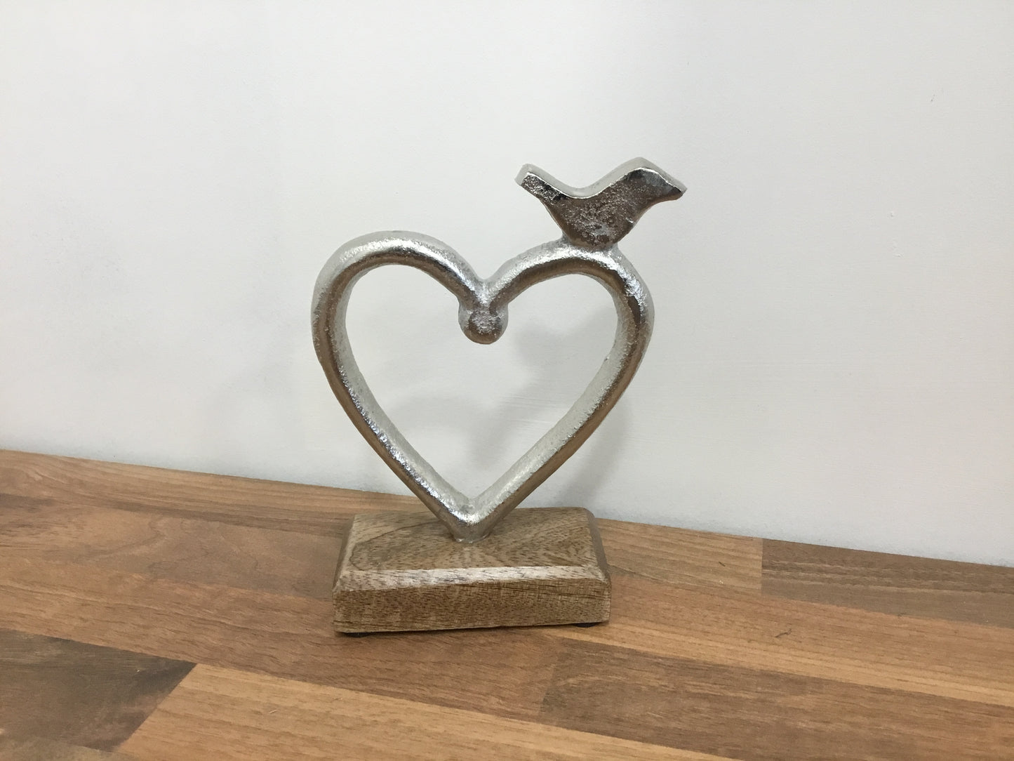 Metal heart with bird on wooden base