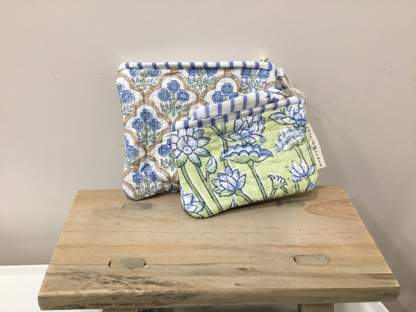Set of two organic cotton zipped pouches.