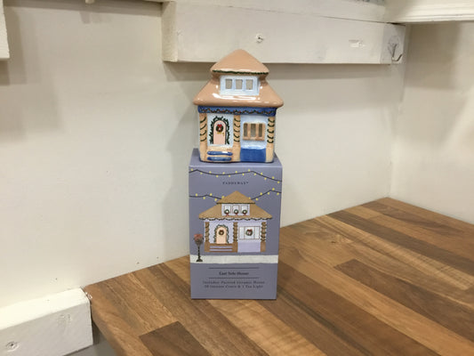 Ceramic east side house with tea light and incense cones.