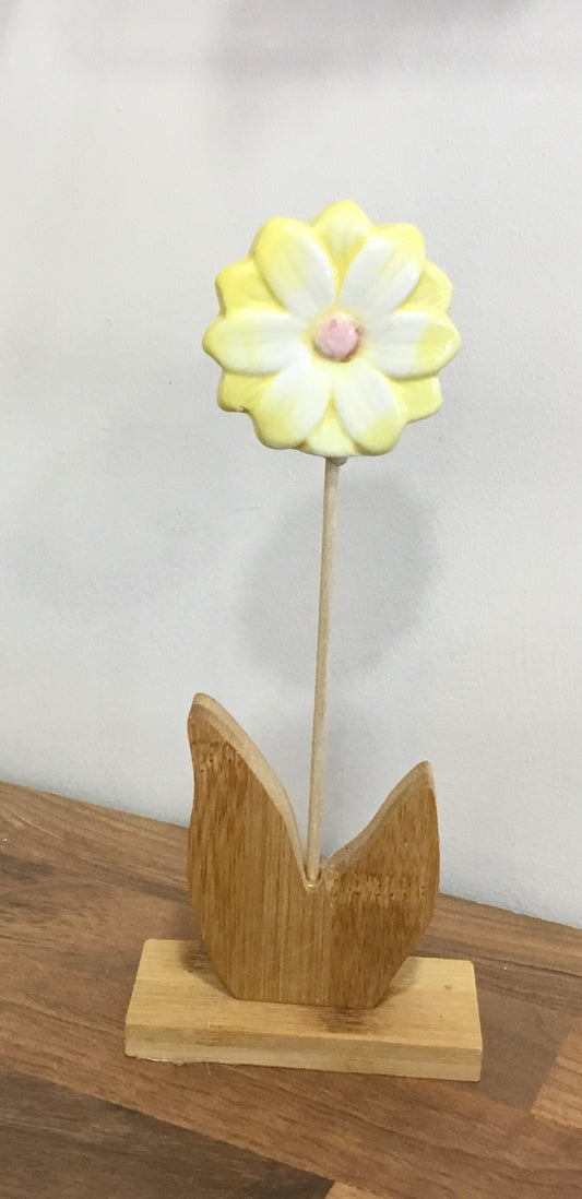 Small ceramic flower on wooden base