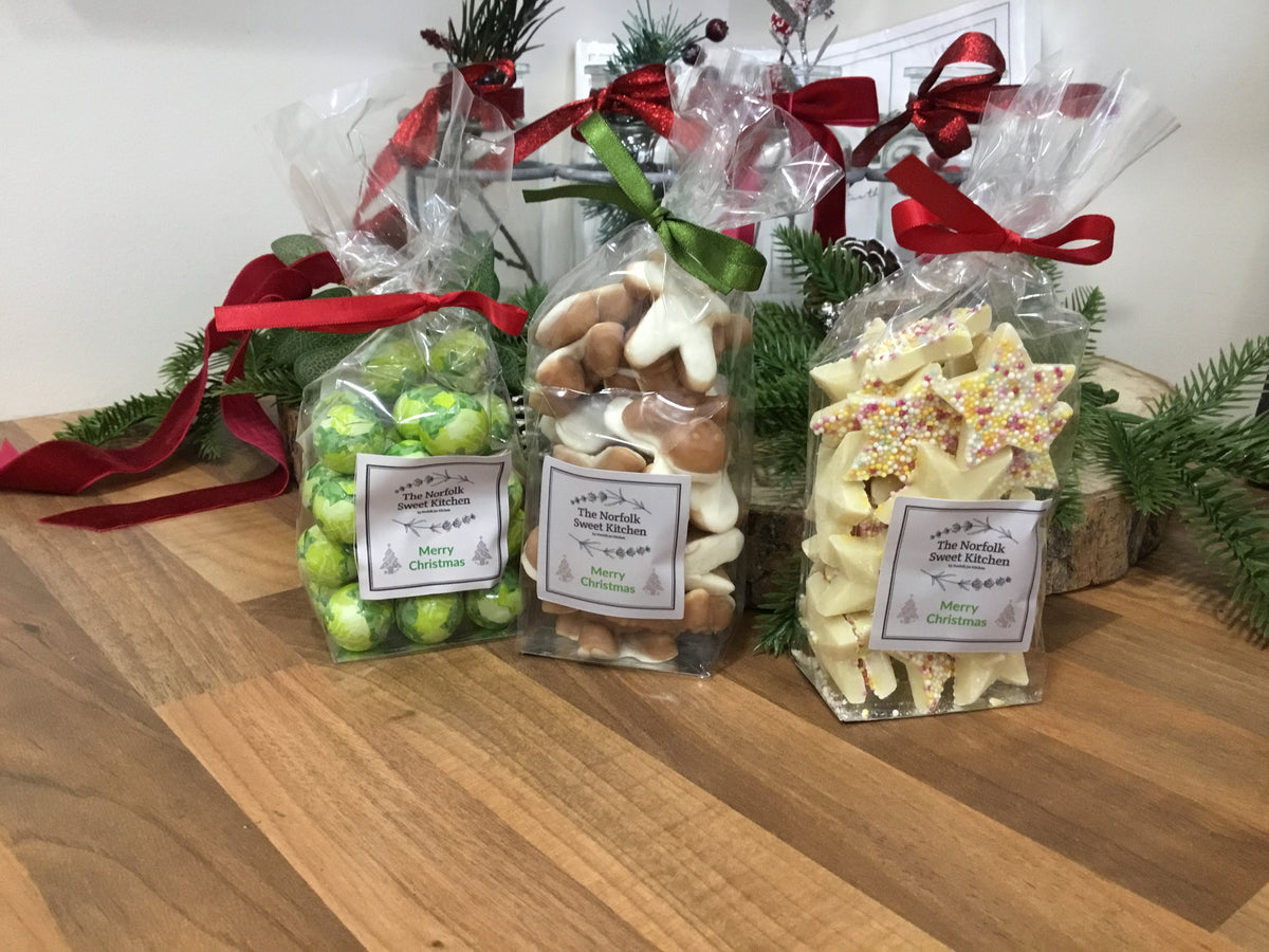 Christmas magic sweets.Gingerbread men, white stars and chocolate sprouts.