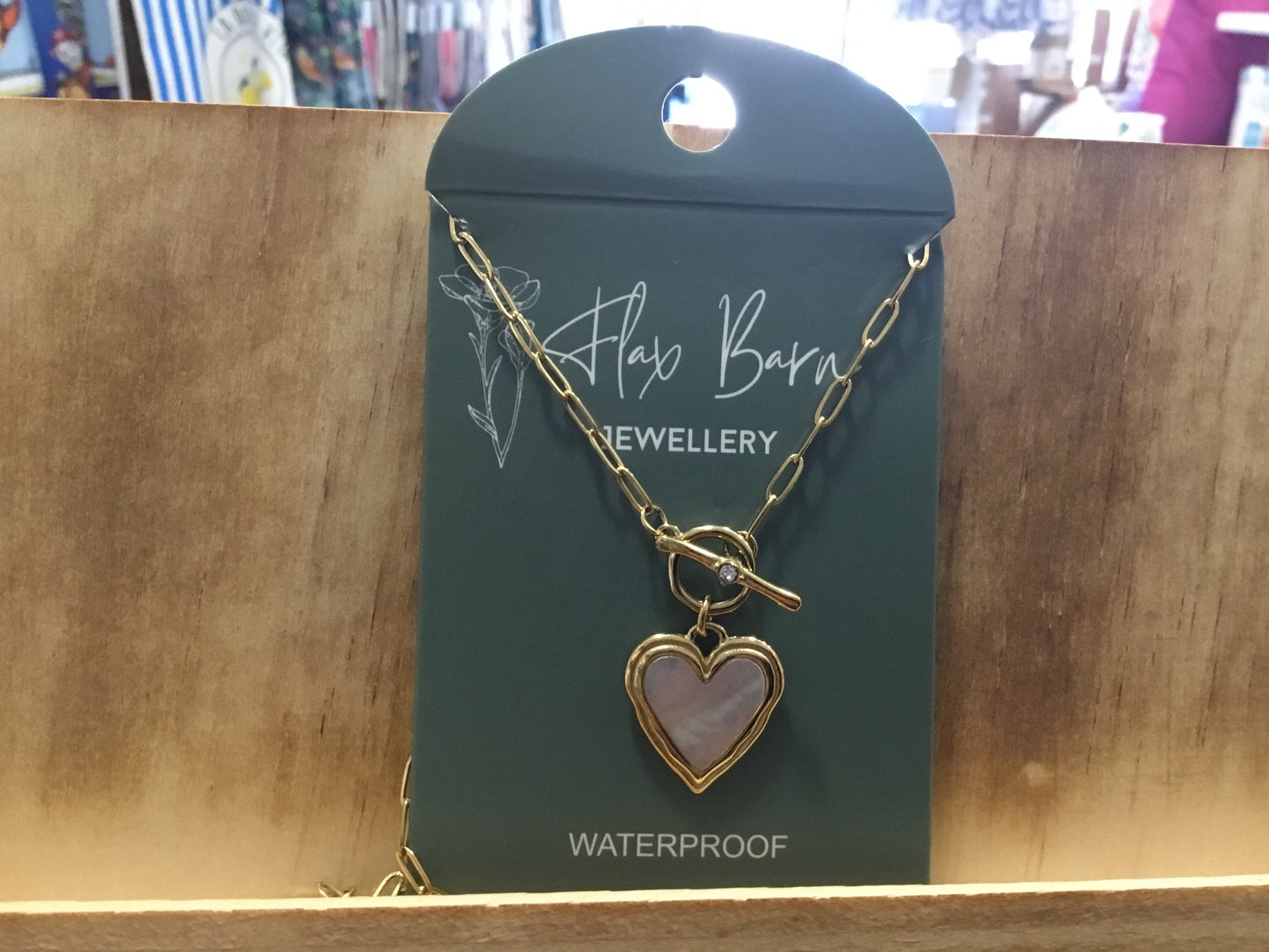 Necklace. Gold colour with large pearlescent heart