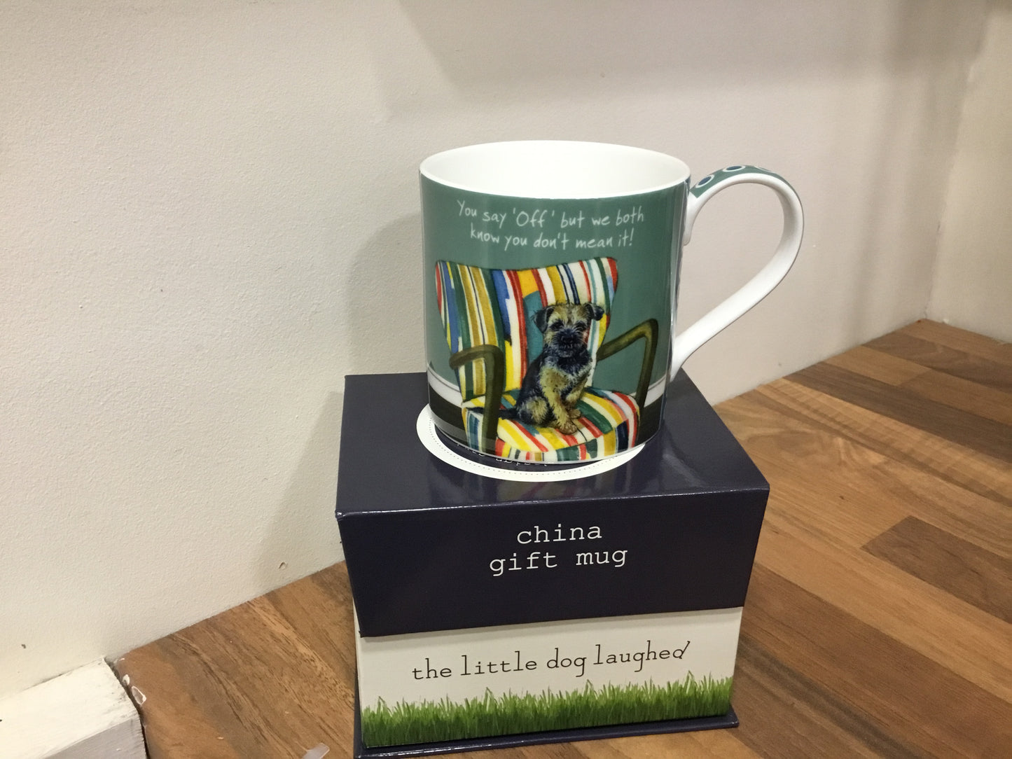 Little dog laughed mug. Off chair.