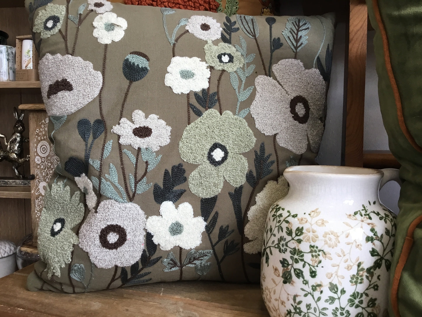 Embroidered green floral cushion