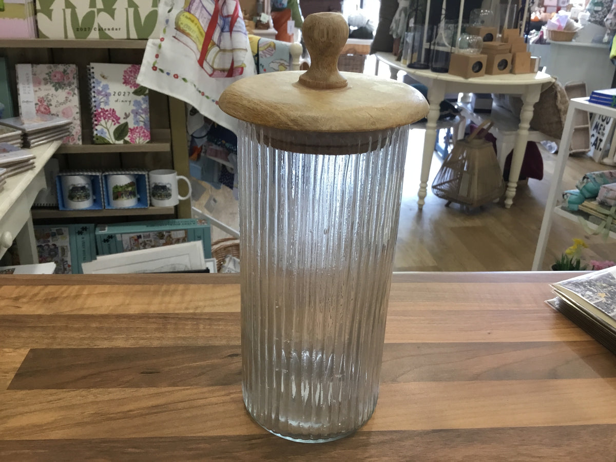 Tall ribbed storage jar with wooden lid