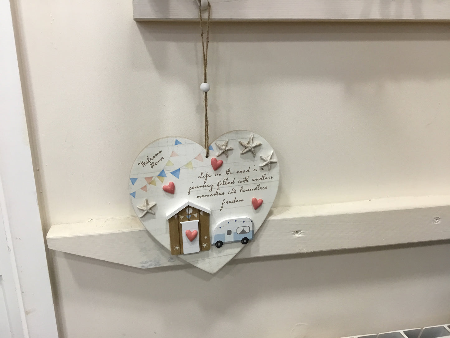 Hanging heart shaped plaque. Life on the road.