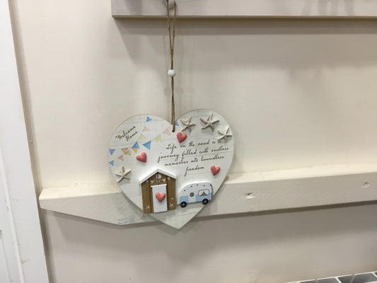 Hanging heart shaped plaque. Life on the road.