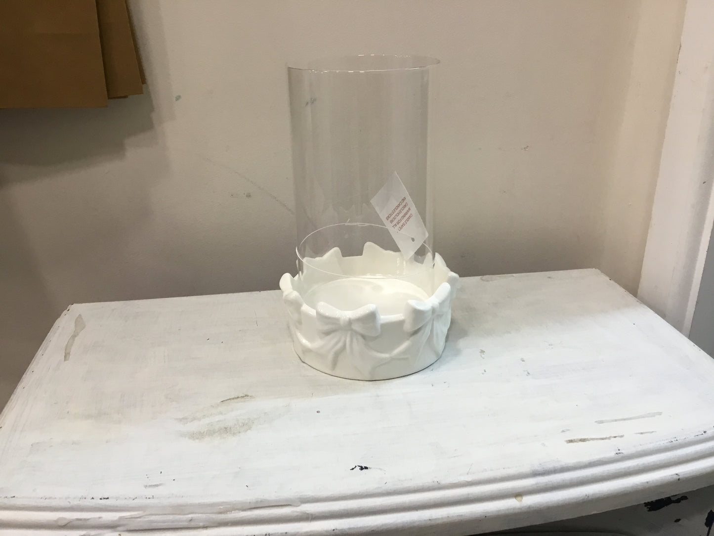 Round bow candle holder with glass insert.