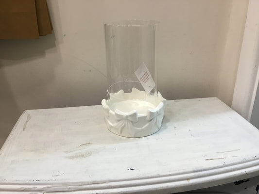 Round bow candle holder with glass insert.