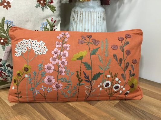 Embroidered rustic orange cushion