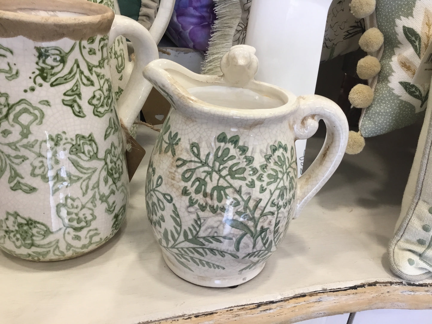 Small green ceramic jug with bird