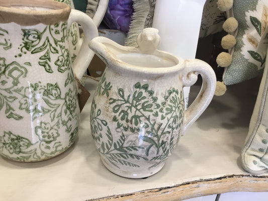 Small green ceramic jug with bird