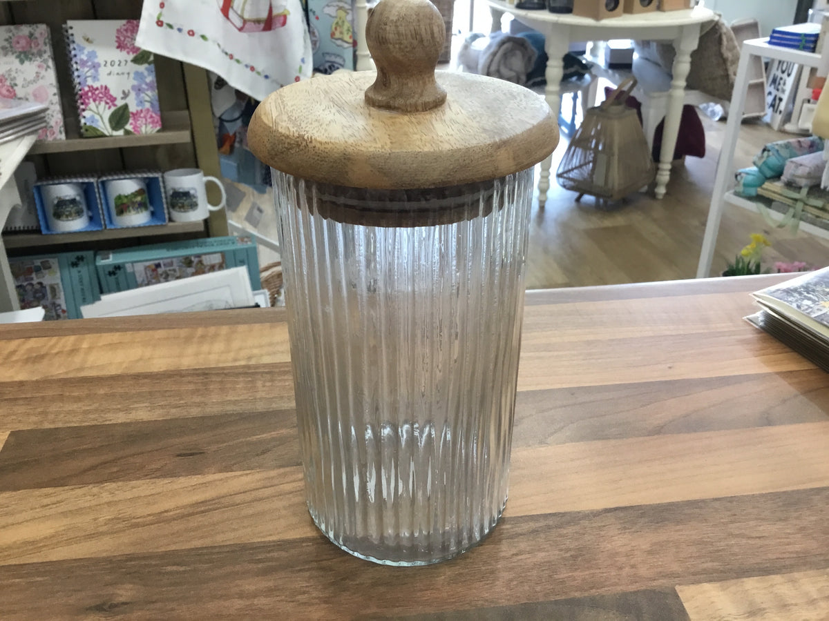 Glass ribbed storage jar with wooden lid