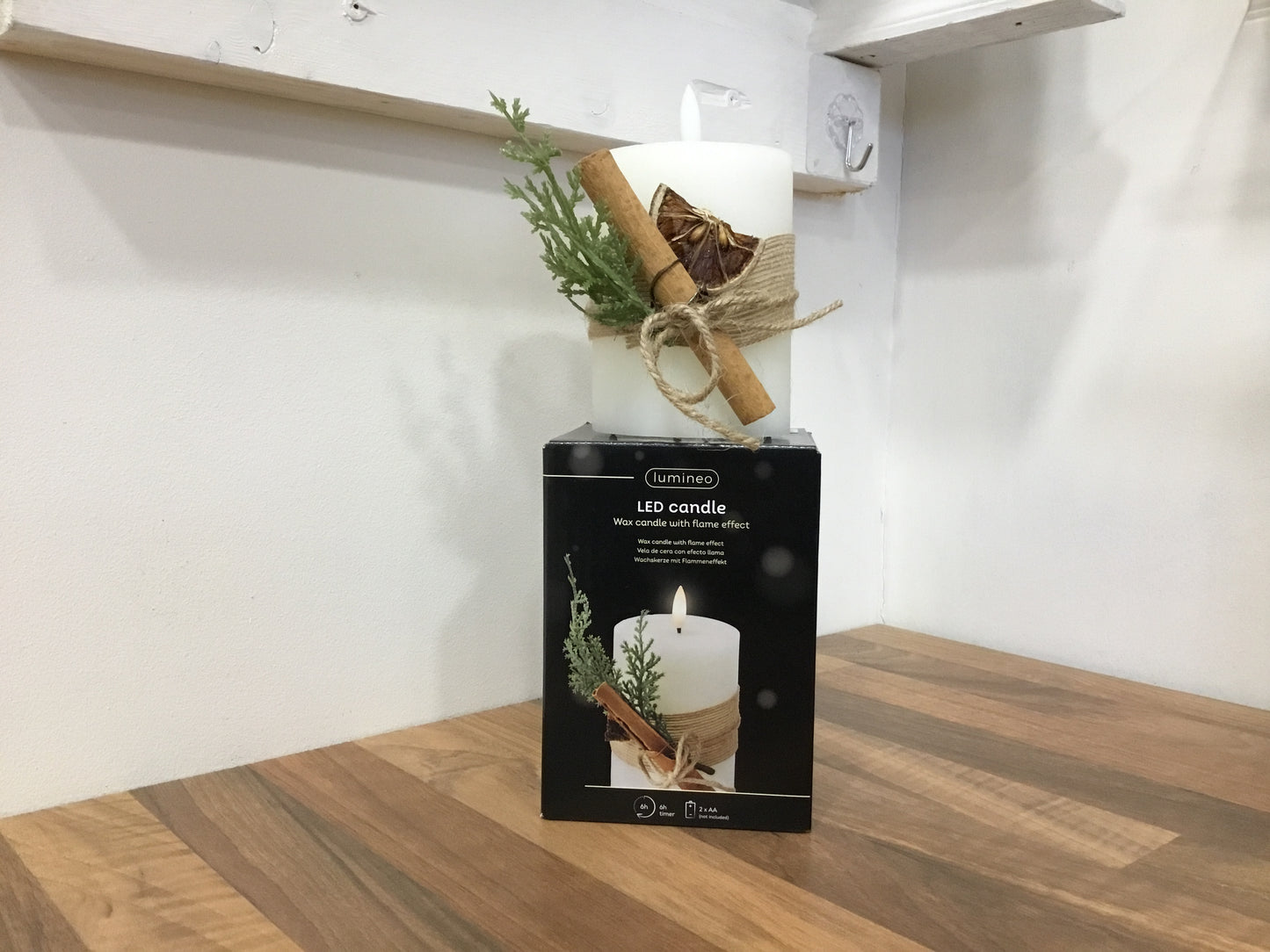 Led candle. With cinnamon stick and foliage